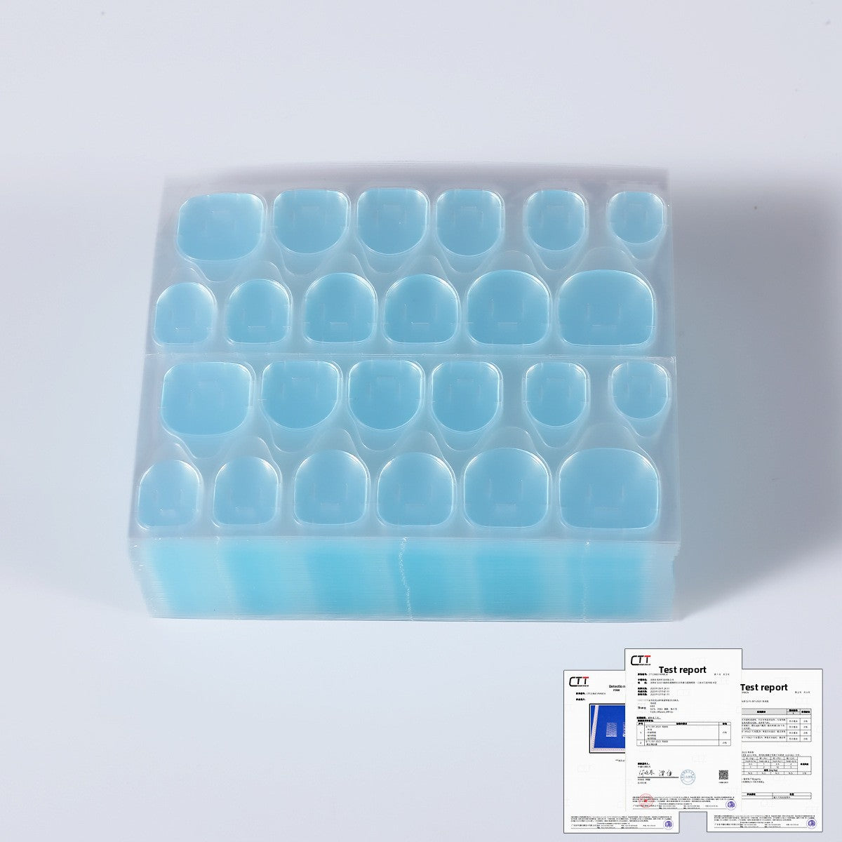 Blue press-on nail tips in a clear storage tray