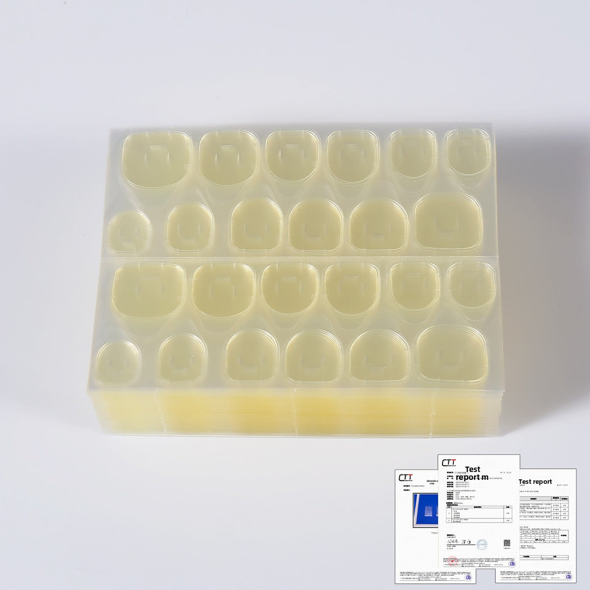 Translucent pale yellow press-on nail tips on clear tray with instruction card below