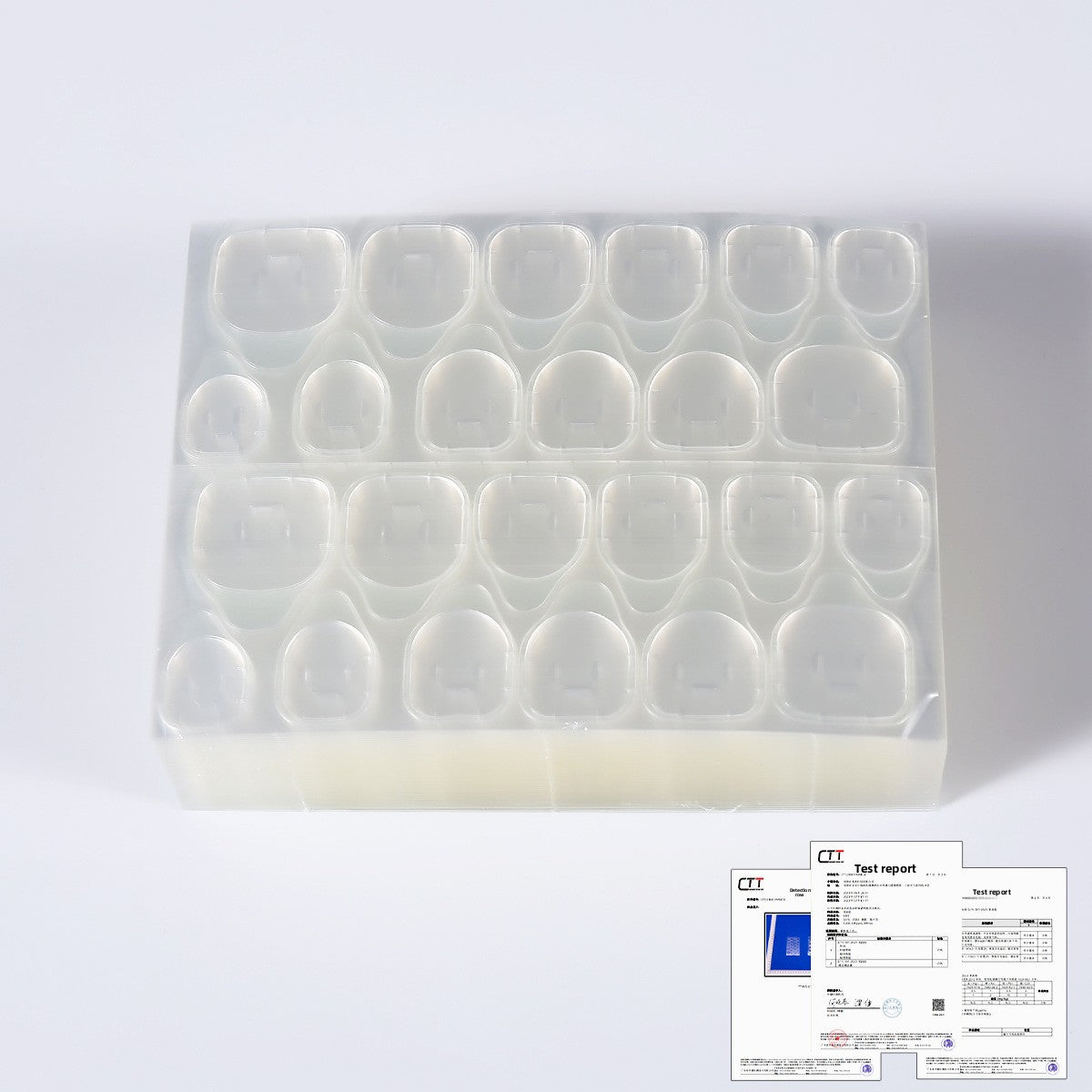 Clear oval press-on nail tips in a plastic tray with nail adhesive kit contents