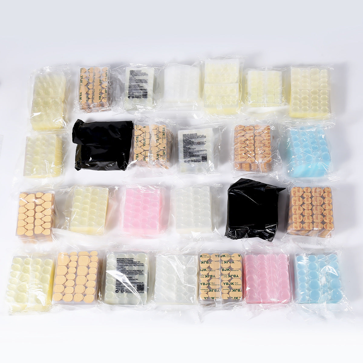 Nail jelly glue kit with assorted press-on nail tips in yellow, pink, and blue packets