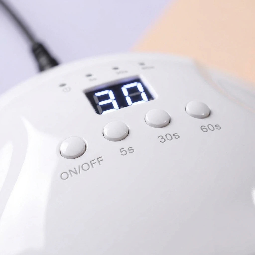 White UV nail lamp control panel with glowing timer screen