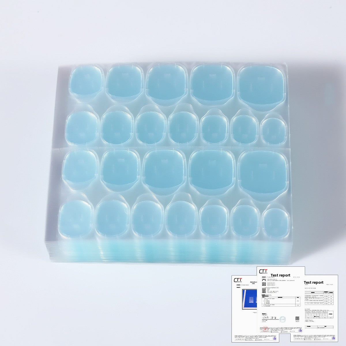 Blue press-on nail tips in a clear storage tray, close view