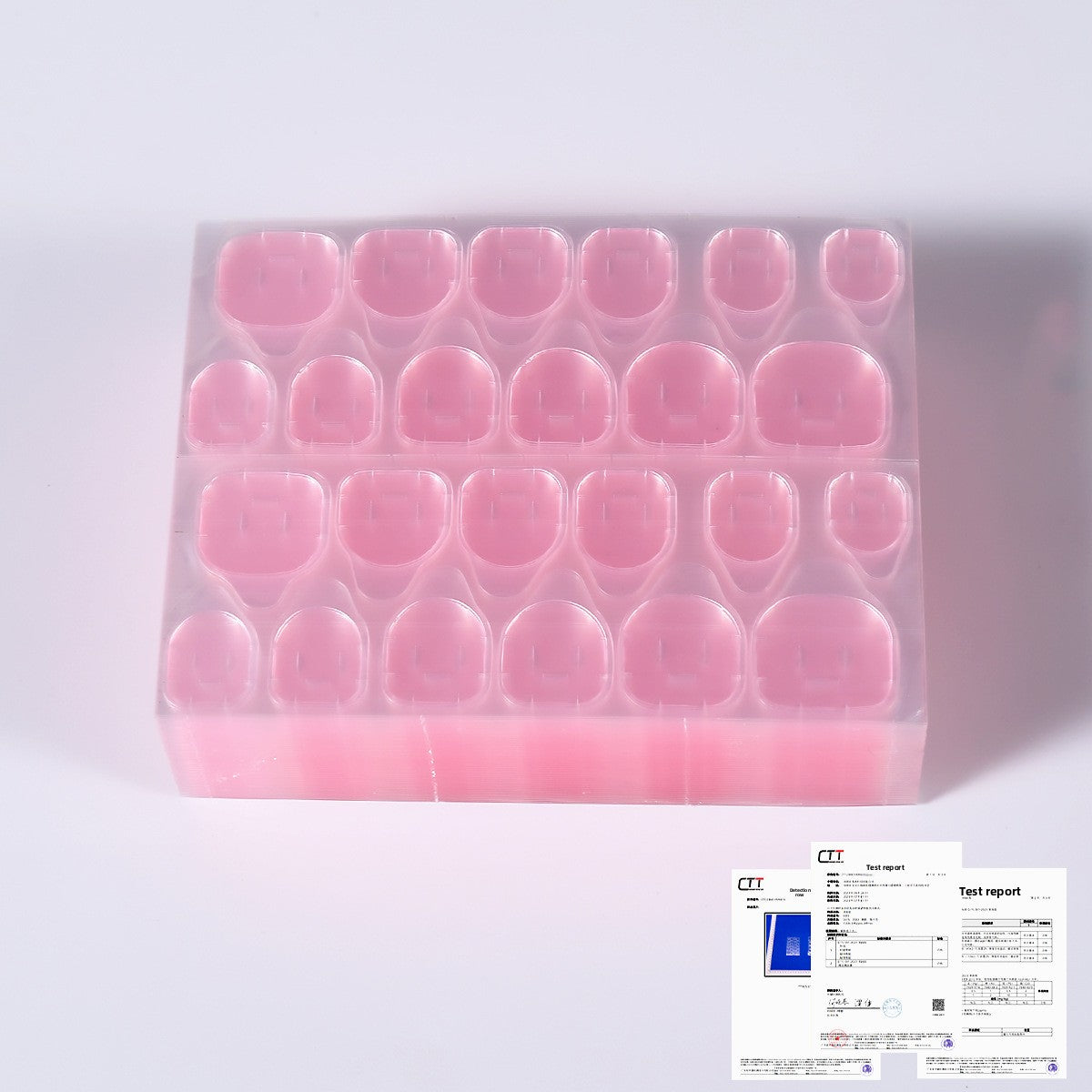 Pink press-on nail tips in a clear storage tray